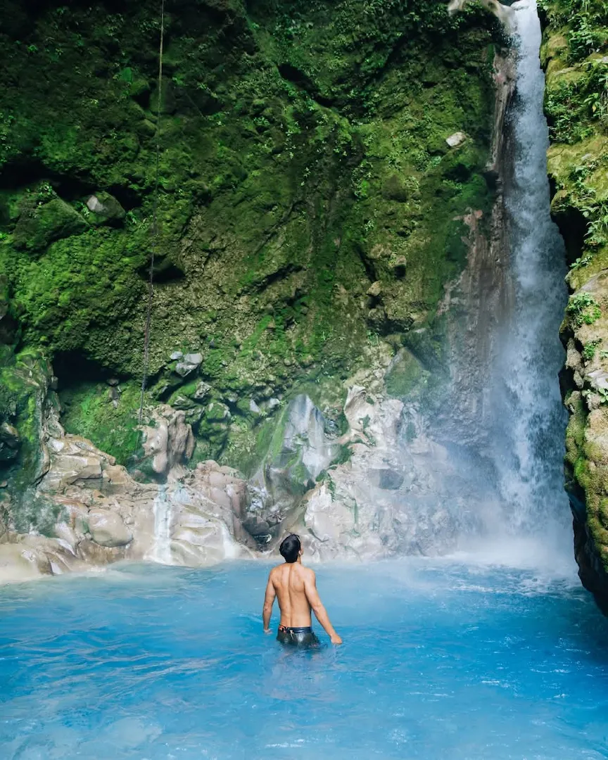 Thermal pool surrounded by jungle vegetation at Sensoria